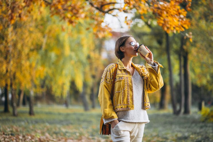 person enjoying drink in fall