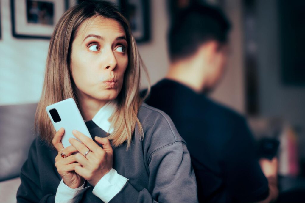 woman hiding a secret on her phone