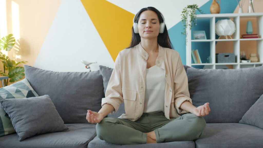 Person meditating on their couch