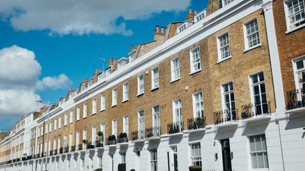 Row of traditional terraced houses under a blue sky